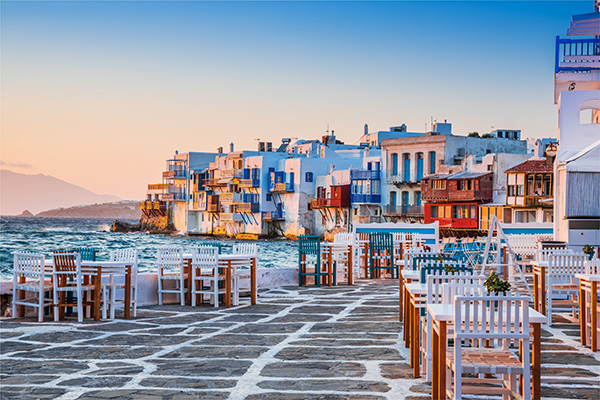 View of the Mykonos coast with blue waters and white-washed houses in the background